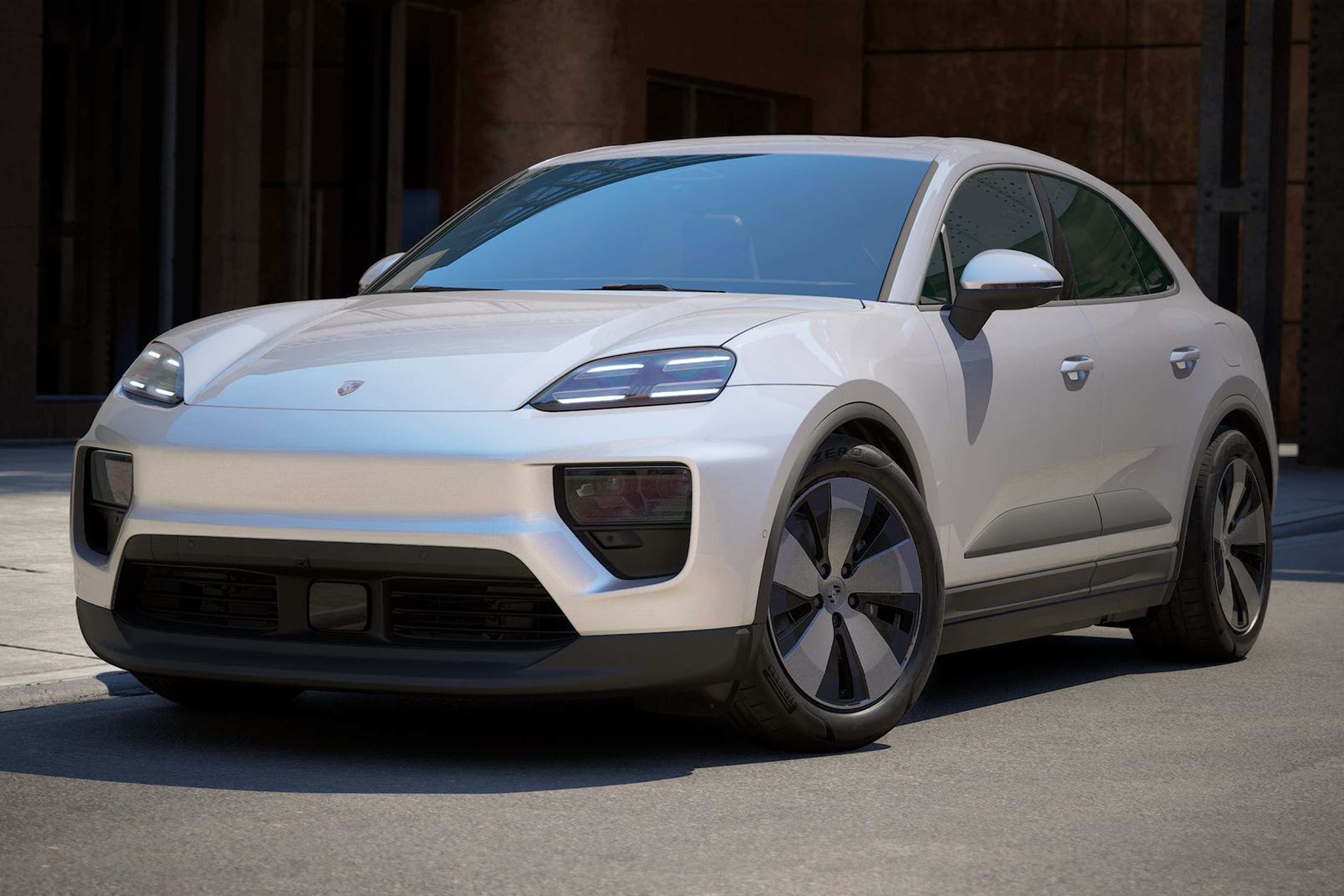 Porsche Macan 4 Ice Grey Metallic -näköala edessä nykyaikaisessa autotallissa, jossa on Matrix LED-valot, Advanced Package -panoraamakatto ja tyylikäs muotoilu.